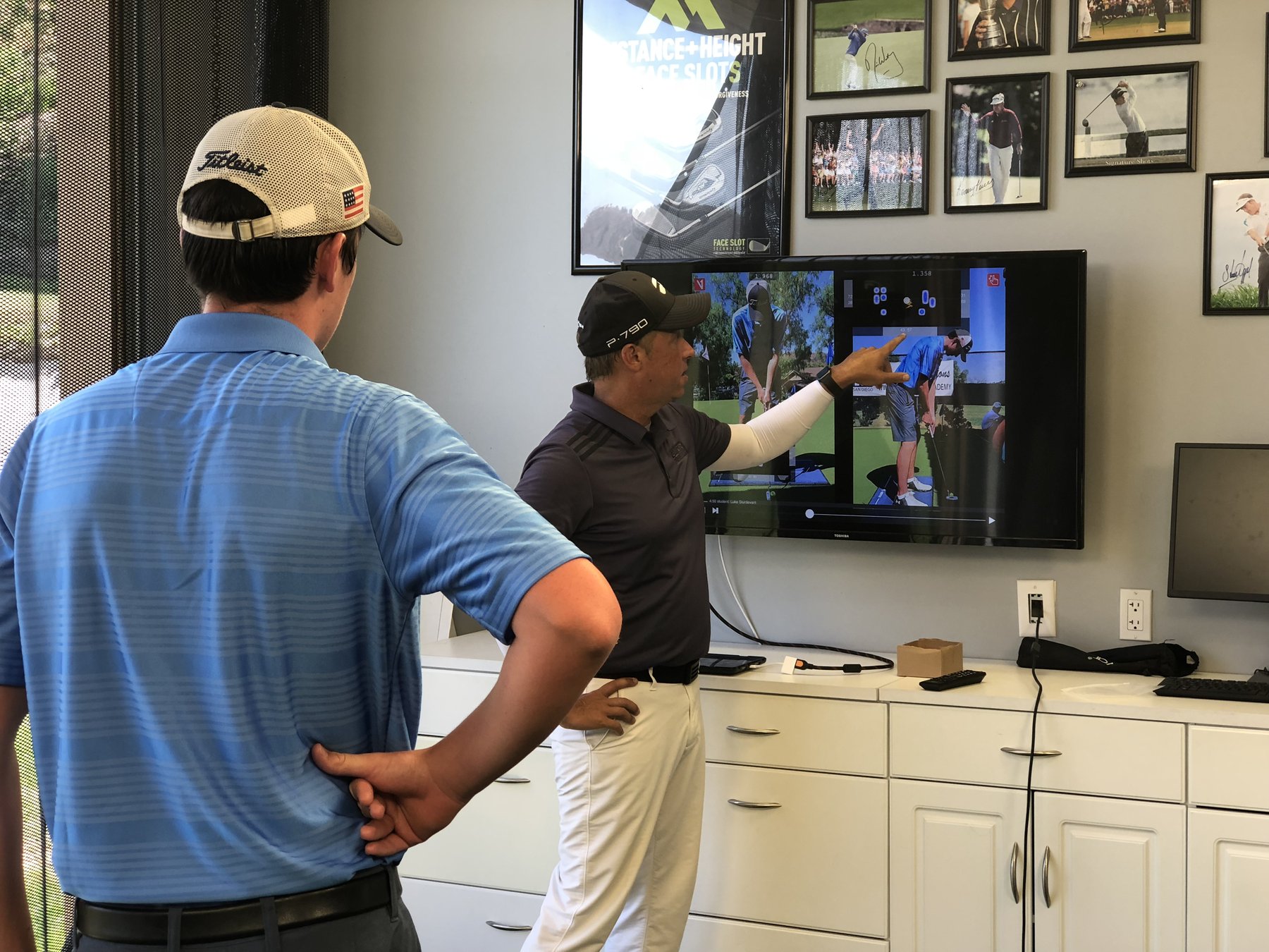 Coach reviewing swing video with a student
