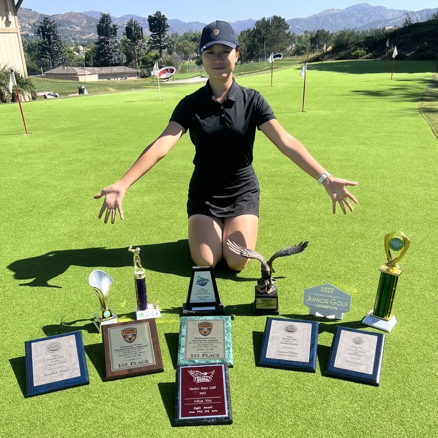 Student with tournament trophies